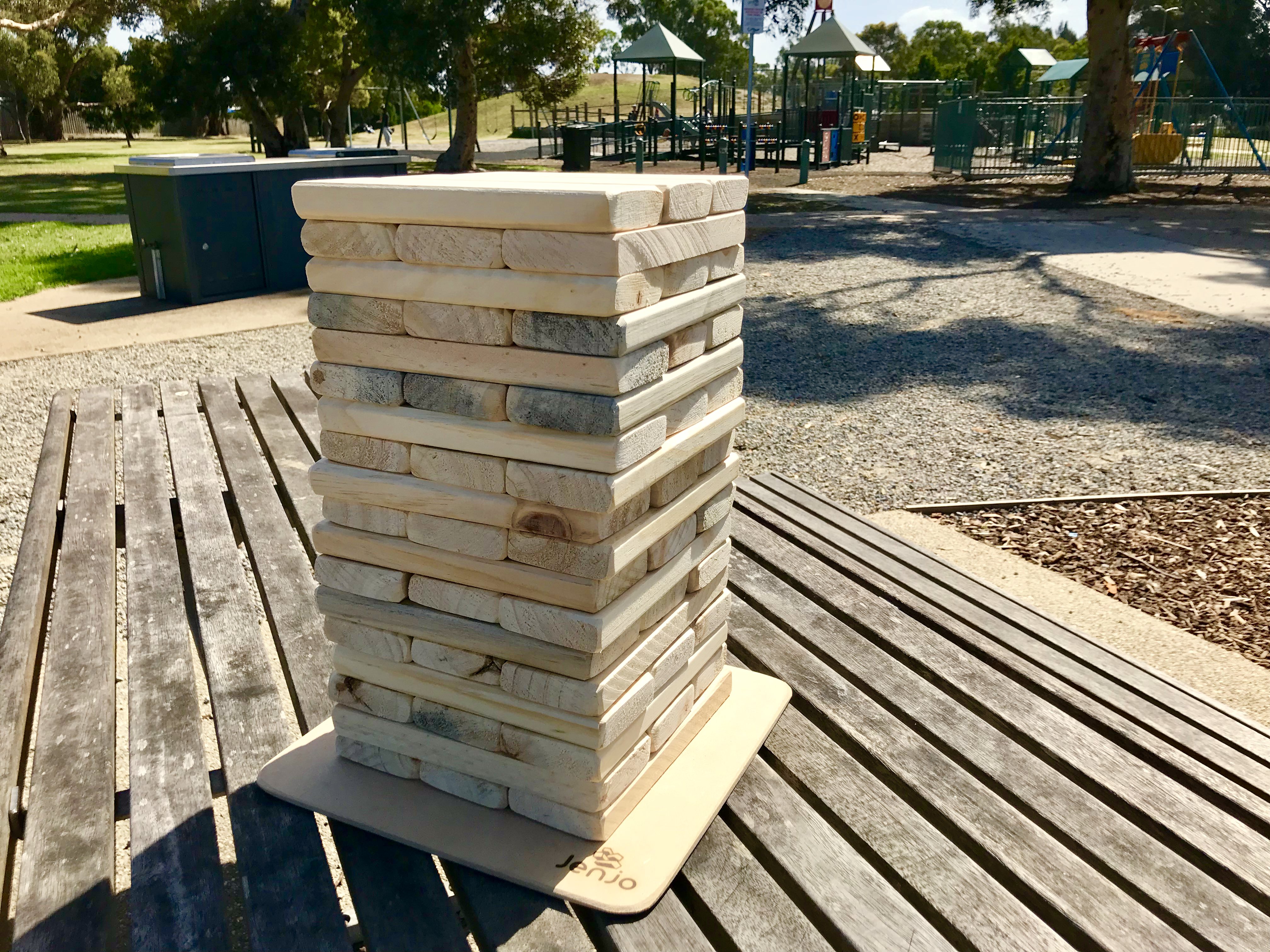 giant jenga game with giant wood blocks and dice